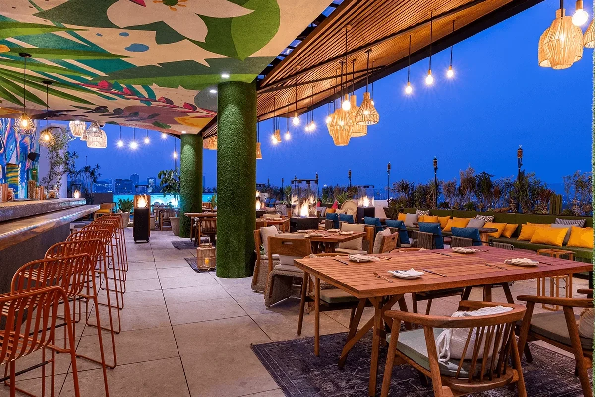 Cabuya, the rooftop restaurant and bar, at dusk with lanterns and fire pits