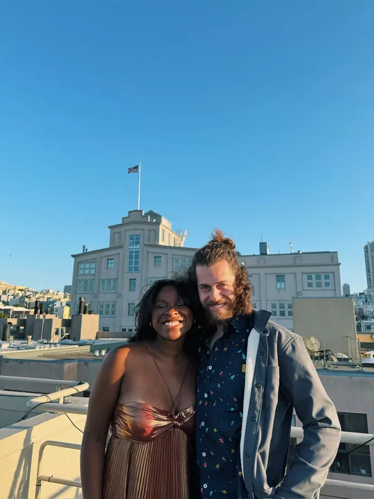 Ciera and Cooper on a rooftop under a clear blue sky