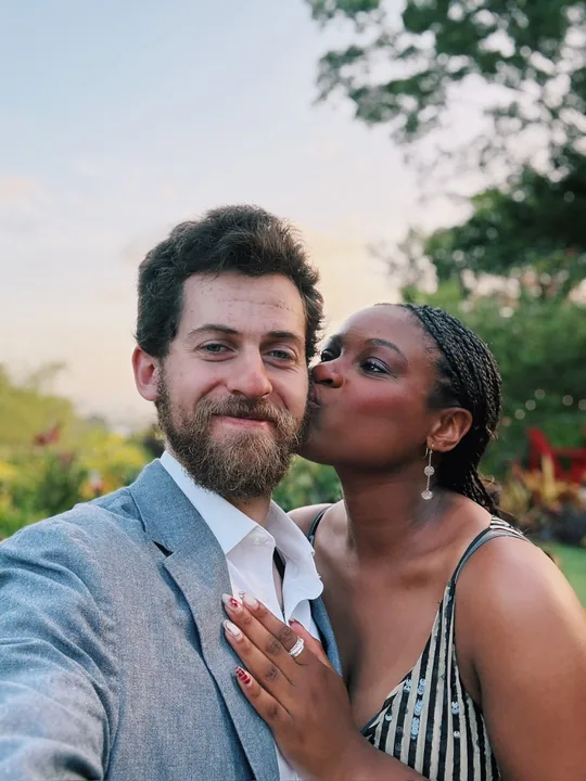 Ciera kissing Cooper on the cheek in golden light
