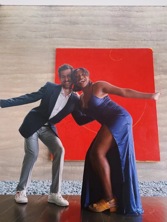 Cooper and Ciera striking a dance pose in front of a red painting