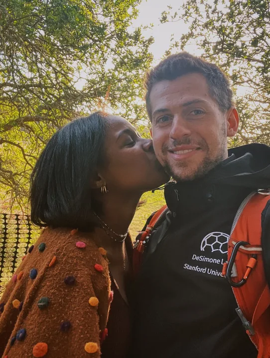 Ciera kissing Cooper outdoors