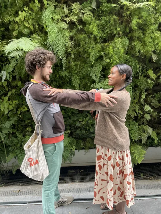 Cooper and Ciera holding hands and laughing on a garden path