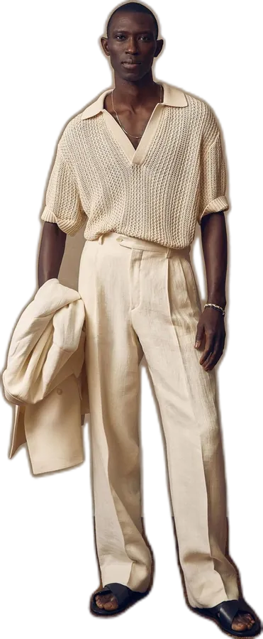 Cream open-knit polo with pleated trousers