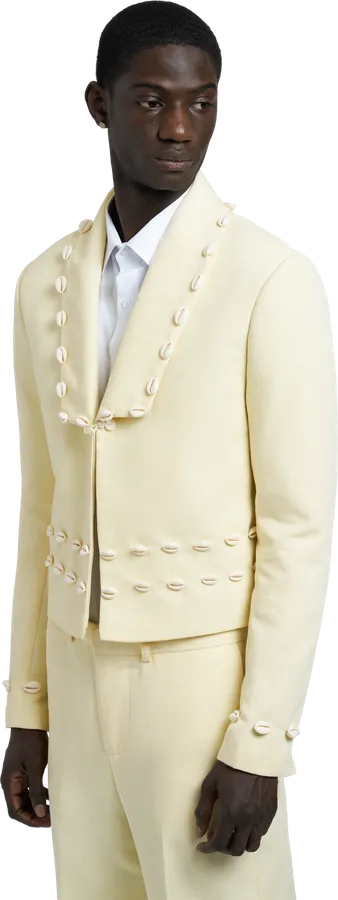 Cream jacket and trousers trimmed with shell buttons